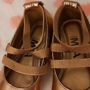 Gold Pink strap shoes.